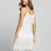 A woman wearing a white Flapper Mini Dress with fringes and a headband.