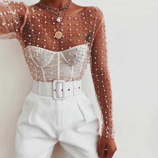 A woman wearing white pants and a Pearl Embellished Crop Top.