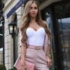 A woman in a Solid Color Bodysuit with Spaghetti Straps posing on the street.