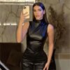 Woman taking a mirror selfie in a Vegan Leather Tank Top and black outfit.