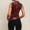 Woman wearing a sleeveless burgundy PU Leather Tank Top and black pants.