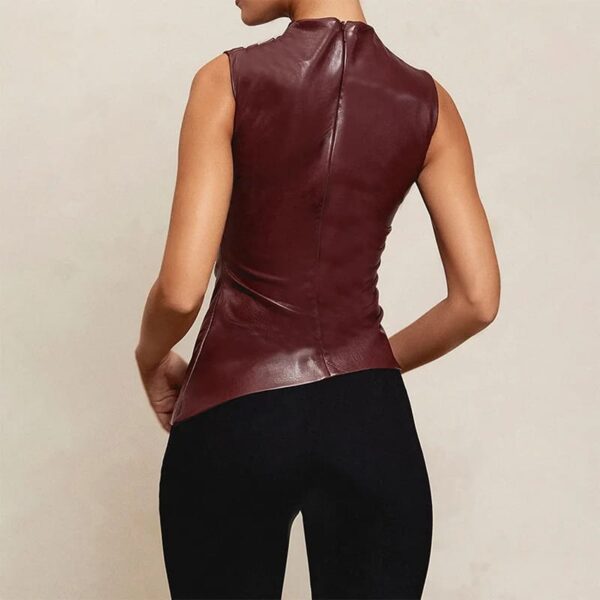 Woman wearing a sleeveless burgundy PU Leather Tank Top and black pants.