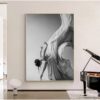 Monochromatic artwork of a woman in flowing drapery, embodying Grace, on a wall beside a grand piano.