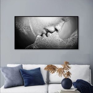 Abstract monochrome artwork depicting a LOVE KISS, displayed above a couch with decorative pillows and a plant to the side.
