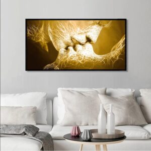 A framed LOVE KISS art piece with gold and black tones, symbolizing a love kiss, hanging above a sofa with white cushions in a modern living room.