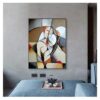 Abstract modern painting hung on a plain wall above a grey sofa with a UNITED IN LOVE tea set on a wooden tray.