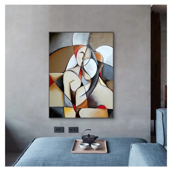 Abstract modern painting hung on a plain wall above a grey sofa with a UNITED IN LOVE tea set on a wooden tray.
