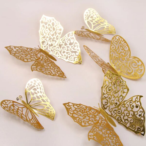 12Pcs Fashion 3D Hollow Butterfly in gold and white, featuring intricate cut-out designs, beautifully scattered on a light surface.