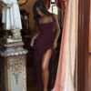 A woman in a Ruffles Trim Square Neck Slit Maxi Dress stands near ornate interior decor, partially behind a curtain.